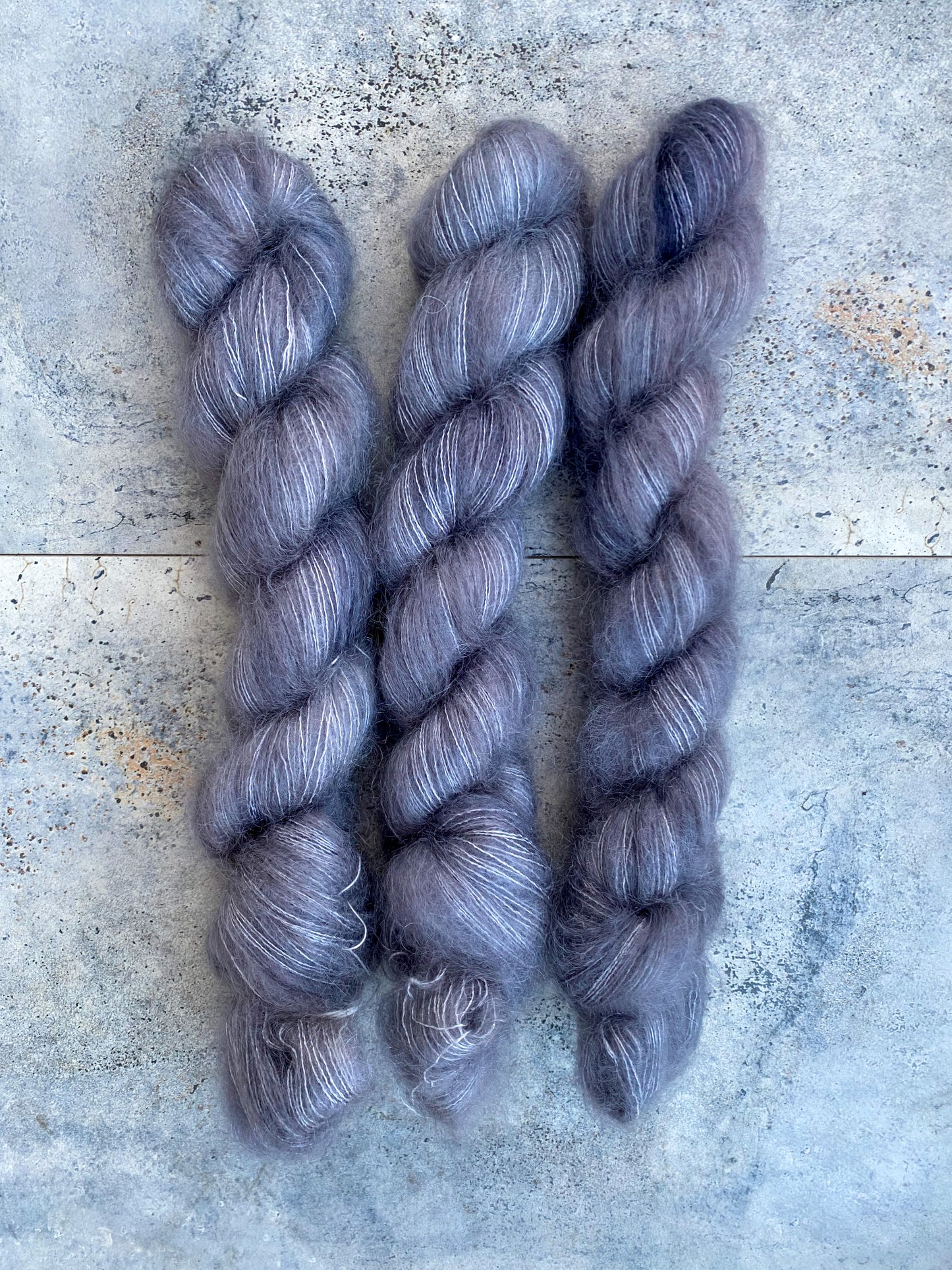 Dark grey yarn on kid mohair lace weight.